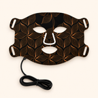 Black face mask with leaf pattern and white accents on a white background