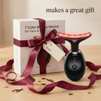 Beauty device with a gift box and red ribbon on a wooden surface, text 'makes a great gift'.