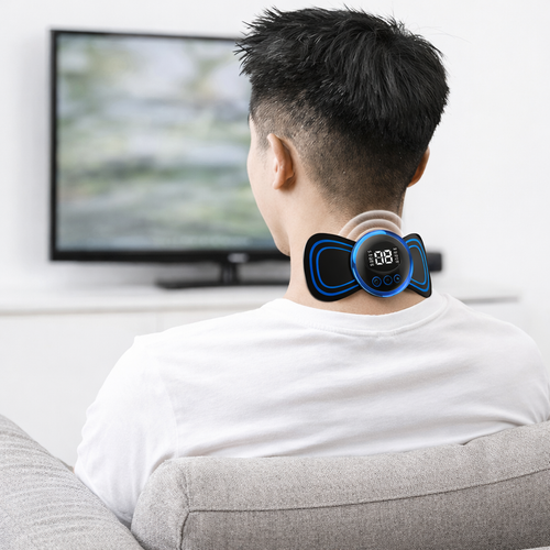 Person using a neck massager device in a living room setting.