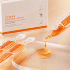 Skincare serum packaging with dropper and box on a beige background