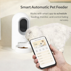 Smart automatic pet feeder with a phone app interface, showing a hand holding a phone with an app on a white background.